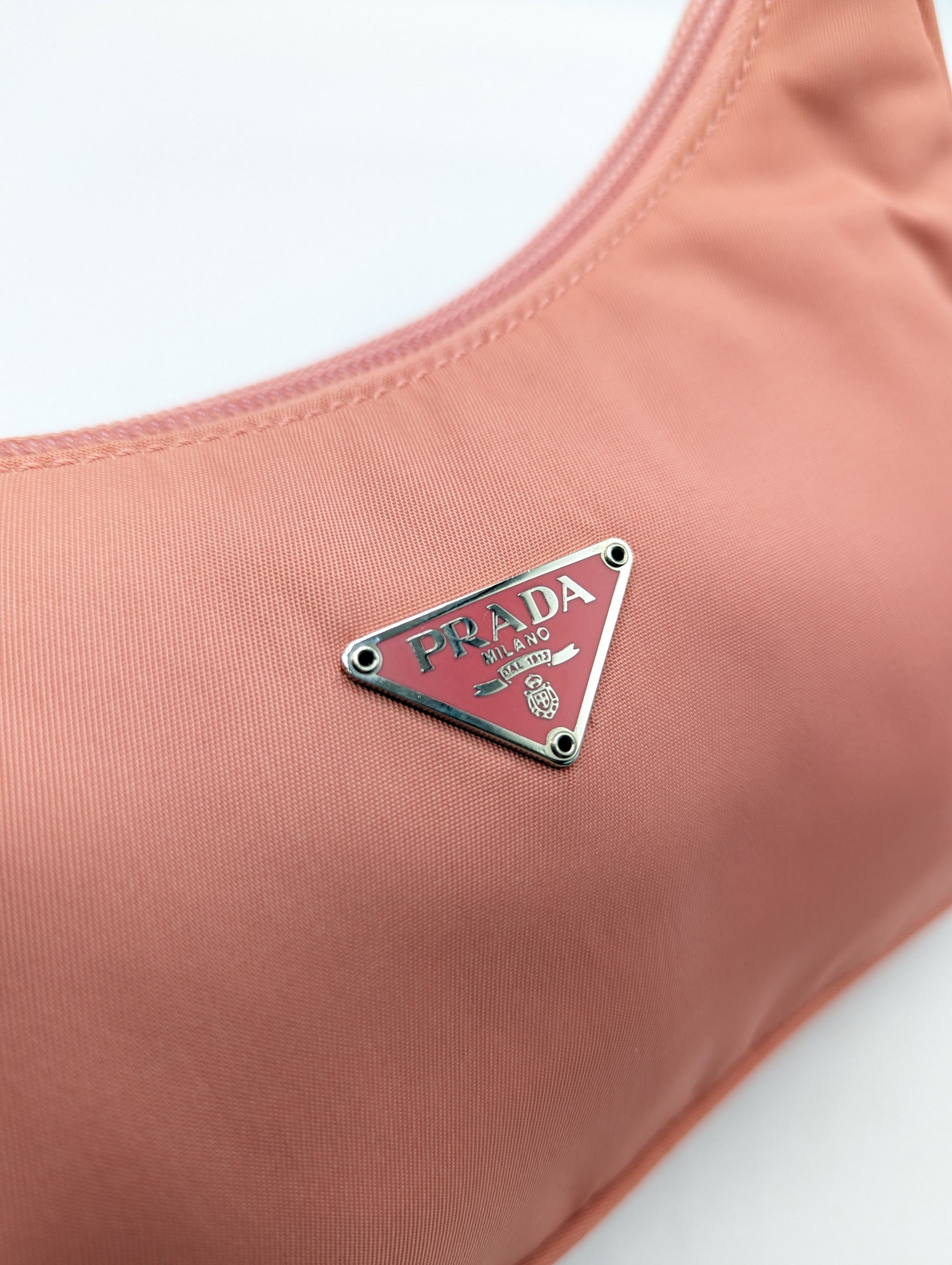 Authentic Prada Pink Solid Nylon Bag on sale at JHROP. Luxury